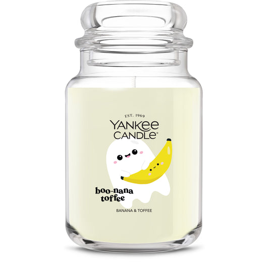 Large glass jar candle with banana and toffee scent, featuring cute ghost and banana illustration for home decor